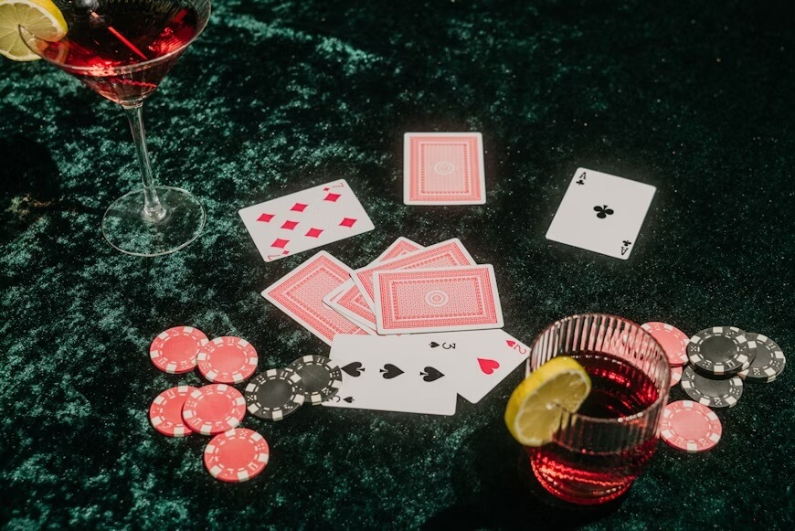 Table de poker avec jetons, cartes et boissons.