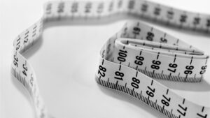 Black and white measuring tape on a white table