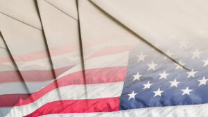 Photocollage of US flag flying and white paper envelopes