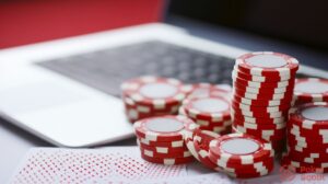 poker chips and laptop with playing cards