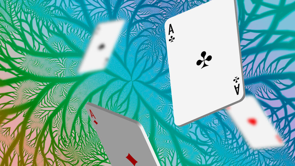Playing cards tumbling in front of a rainbow fractal background