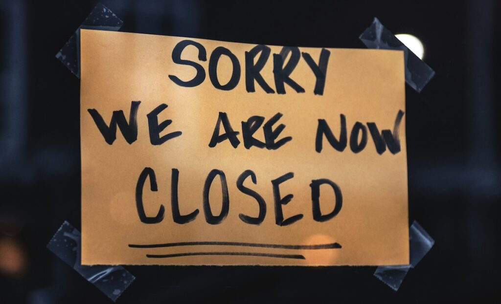 A photo a closed sign on a window.