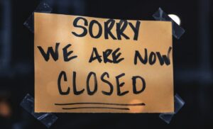 A photo a closed sign on a window.