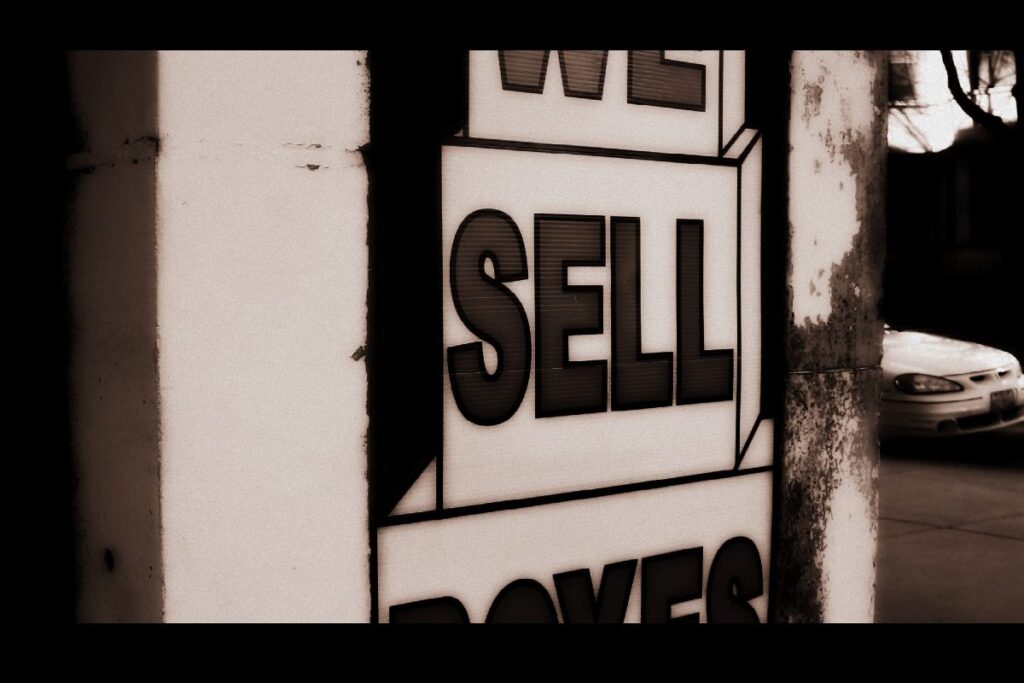 A sign that reads "sell"