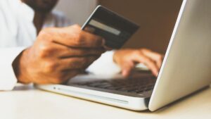 A photo of someone using a credit card on laptop.