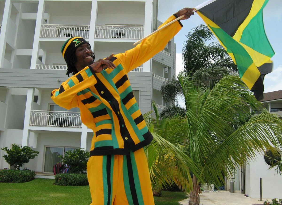 Man in Jamaican attire doing the Usain Bolt pose