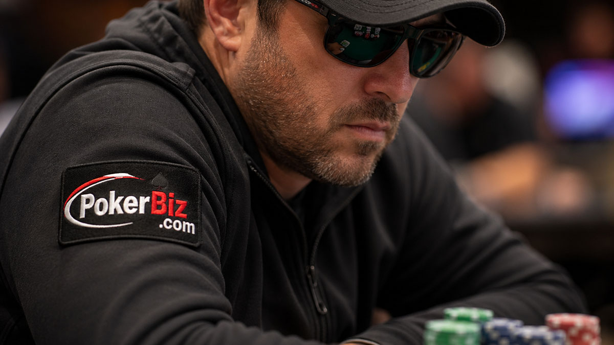 Poker player at the table, sporting PokerBiz.com patch