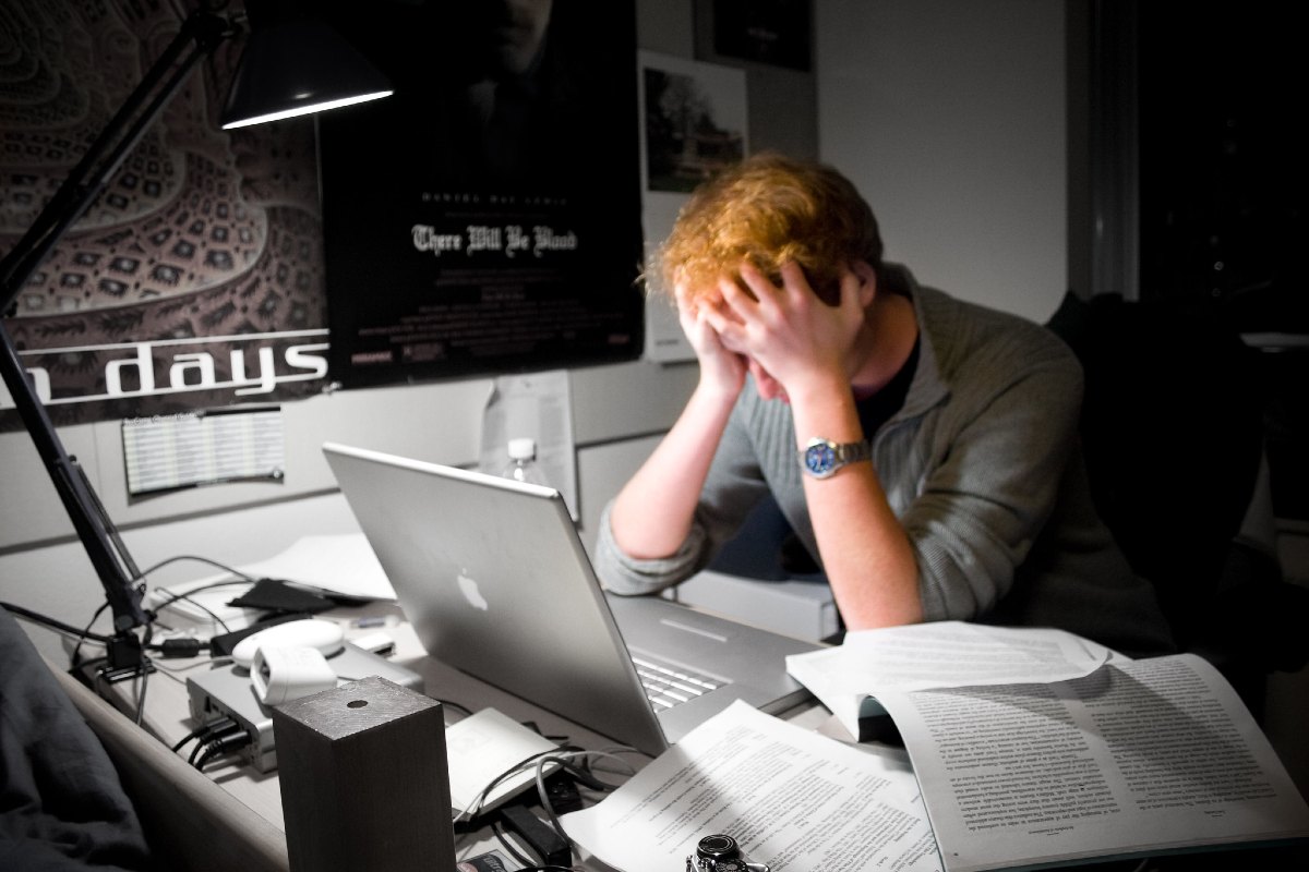 A man sitting at his computer, frustrated