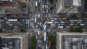 Birds-eye view of a downtown intersection with heavily gridlocked traffic.
