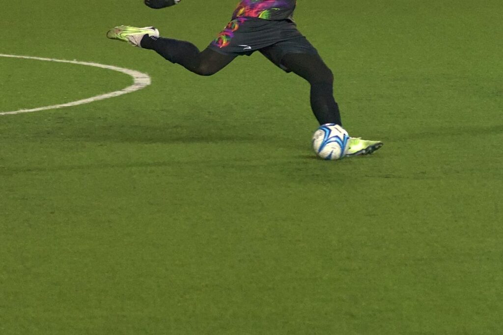 A soccer player kicking a ball.