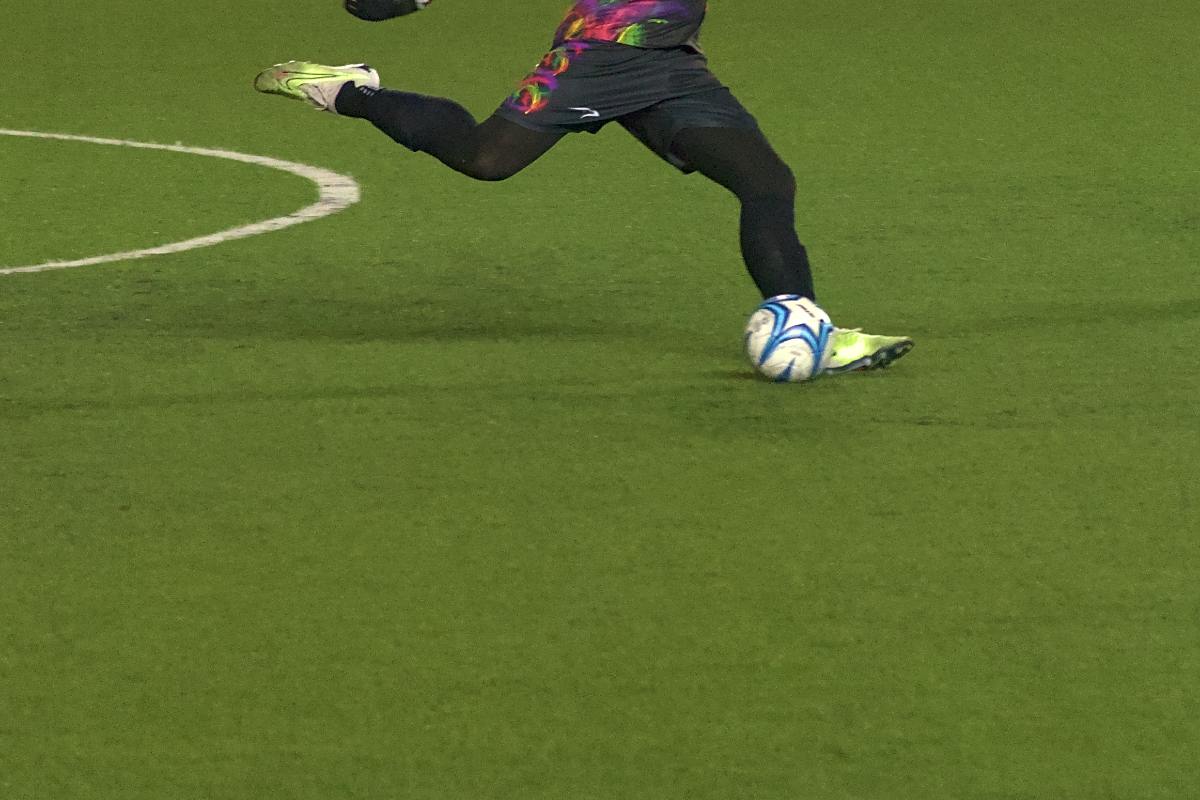 A soccer player kicking a ball.