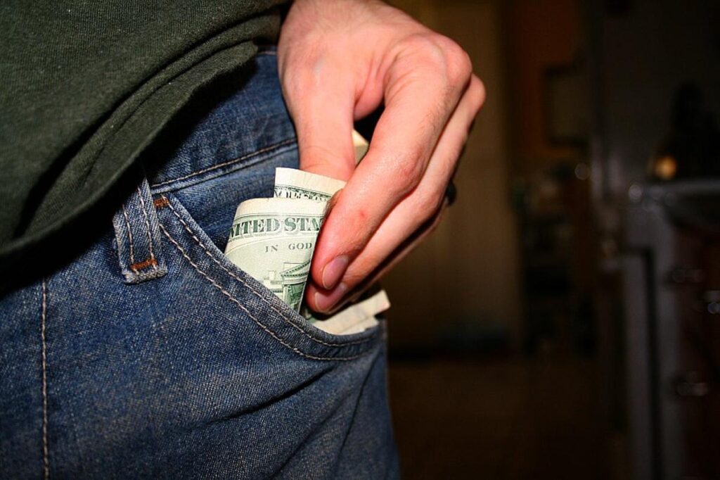 Money going into a pocket