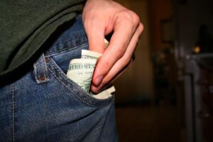 Money going into a pocket
