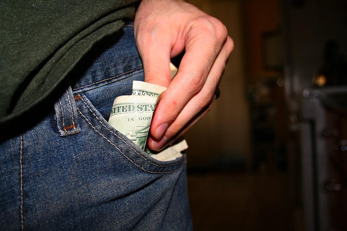 Money going into a pocket