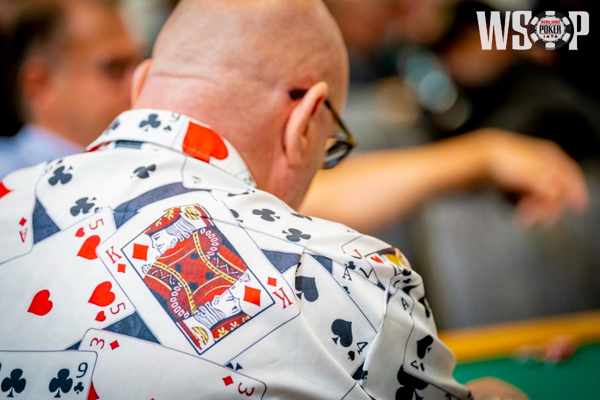 A man wears a shirt with a king on it.